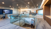 Photo of Capital One offices showing staircase, reception desk and people moving about