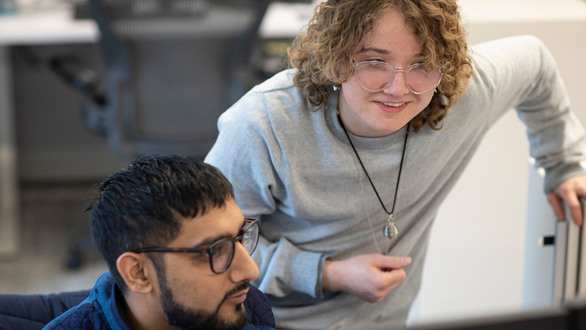 Candid photo of two OCC colleagues looking at something together