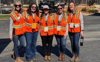 Caterpillar team members pose for a group as part of a Woman in Construction group