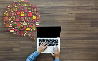 A person typing on a laptop and various icons coming from it are shown.
