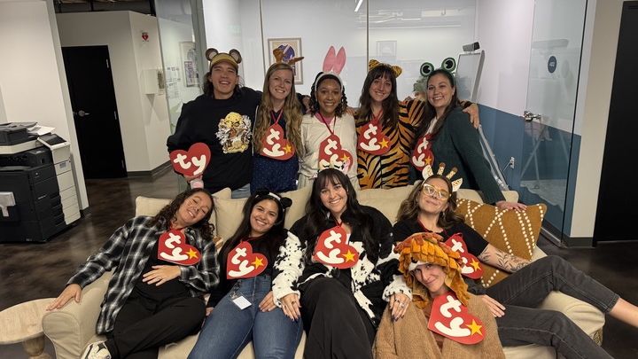 Monday.com employees pose with TY tags as costumes.