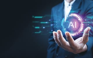 An open hand is outstretched with a digital illustration featuring the letters AI hovering over the palm.